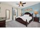 Charming bedroom featuring a dark wood bed frame, nightstands, and a cozy, well-lit ambiance at 640 Lasso Dr, Kissimmee, FL 34747