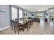 Bright dining area with view to the living room and pool; large glass table complements the open floor plan at 640 Lasso Dr, Kissimmee, FL 34747