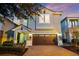 Two-story home showcasing a well-manicured front yard and a brick paved driveway leading to an attached garage at 640 Lasso Dr, Kissimmee, FL 34747