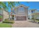 Charming two-story home with a brick driveway, well-maintained landscaping, and a neutral color scheme at 640 Lasso Dr, Kissimmee, FL 34747