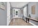 Welcoming foyer with tile flooring, a decorative front door, natural light, and a bench for seating at 640 Lasso Dr, Kissimmee, FL 34747