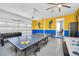 Garage turned game room featuring fun wall murals, ping pong table, and ceiling fan at 640 Lasso Dr, Kissimmee, FL 34747