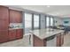 Stylish kitchen featuring granite countertops, stainless steel appliances, an island with seating, and an open layout at 640 Lasso Dr, Kissimmee, FL 34747