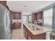 Well-lit kitchen featuring granite countertops, stainless steel appliances, ample cabinet space, and tile flooring at 640 Lasso Dr, Kissimmee, FL 34747