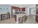 Bright kitchen with stainless steel appliances, granite countertops, island seating, and access to the dining area at 640 Lasso Dr, Kissimmee, FL 34747