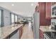 Modern kitchen with granite countertops, stainless steel appliances, an island, and an open floor plan at 640 Lasso Dr, Kissimmee, FL 34747