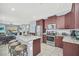 Modern kitchen with stainless steel appliances, granite counters, kitchen island, and open layout to the living area at 640 Lasso Dr, Kissimmee, FL 34747