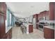 Spacious kitchen featuring stainless steel appliances, granite countertops, island with barstool seating, and tile flooring at 640 Lasso Dr, Kissimmee, FL 34747
