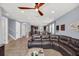 Inviting living room with tile flooring, ceiling fan, and open access to the kitchen and dining area at 640 Lasso Dr, Kissimmee, FL 34747
