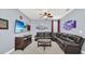 Spacious living room with a leather sectional and large flat screen TV at 640 Lasso Dr, Kissimmee, FL 34747