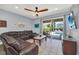 The living room features a comfortable sectional sofa, ceiling fan, and a view of the pool area at 640 Lasso Dr, Kissimmee, FL 34747