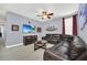 Spacious living room with large leather sectional and flat screen TV at 640 Lasso Dr, Kissimmee, FL 34747