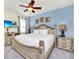 Comfortable main bedroom featuring a decorative headboard and a flat-screen TV at 640 Lasso Dr, Kissimmee, FL 34747