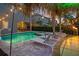 A backyard with an in-ground pool, sun loungers, tiki torches, and palm trees at 640 Lasso Dr, Kissimmee, FL 34747