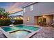 The in-ground pool with a built-in spa and a brick paver deck and patio area at 640 Lasso Dr, Kissimmee, FL 34747