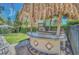 Outdoor poolside bar area featuring a tiki hut roof, a tv, a bar, and a grill at 640 Lasso Dr, Kissimmee, FL 34747