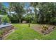 Expansive backyard with mature trees, a seating area, and lush greenery, creating a private outdoor retreat at 750 W May St, Deland, FL 32720