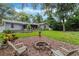 Spacious backyard with a fire pit and screened porch offers a relaxing outdoor space at 750 W May St, Deland, FL 32720