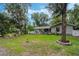 Expansive backyard features a charming patio, fire pit, and lush greenery at 750 W May St, Deland, FL 32720