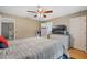 Comfortable bedroom with a ceiling fan, dresser with a TV on top, and an open door to an ensuite bathroom at 750 W May St, Deland, FL 32720