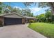 Charming single-story home with a well-manicured lawn and two-car garage at 750 W May St, Deland, FL 32720