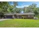 Well-maintained single-story home with brick accents, a manicured lawn and a two-car garage at 750 W May St, Deland, FL 32720