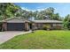 Charming single Gathering home with a well-manicured lawn and beautiful landscaping at 750 W May St, Deland, FL 32720