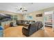 Spacious living room featuring hardwood floors, a ceiling fan, and a large sectional couch at 750 W May St, Deland, FL 32720