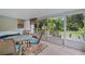 Enclosed patio with an outdoor dining set and seating area, perfect for relaxation and entertaining guests at 750 W May St, Deland, FL 32720