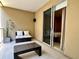 Balcony showcasing glass railings, comfortable seating, and views of trees and sunshine, providing a relaxing outdoor space at 7667 Recife Dr, Kissimmee, FL 34747