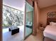 Balcony view, accessible from bedroom, boasts glass railings and seating area for relaxation and enjoyment of the outdoors at 7667 Recife Dr, Kissimmee, FL 34747