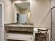 Stylish bathroom features double sinks, granite countertops, vanity seating, and a glass shower at 7667 Recife Dr, Kissimmee, FL 34747