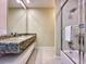 Bathroom featuring shower with sliding glass doors and granite vanity top at 7667 Recife Dr, Kissimmee, FL 34747