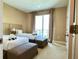 Cozy bedroom featuring two twin beds, soft lighting, and a sliding glass door to a balcony at 7667 Recife Dr, Kissimmee, FL 34747