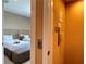 Hallway with elevator access leads to a bedroom featuring two beds, offering convenience and comfortable accommodations at 7667 Recife Dr, Kissimmee, FL 34747