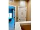 Hallway to bedroom with balcony and elevator access offers convenient accessibility and connection to outdoor serenity at 7667 Recife Dr, Kissimmee, FL 34747