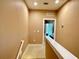 Hallway view of bedroom with sliding glass doors to outdoor space and trees at 7667 Recife Dr, Kissimmee, FL 34747