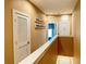 Bright hallway features neutral walls, white doors, and an eye-catching modern art installation at 7667 Recife Dr, Kissimmee, FL 34747