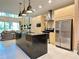 Modern kitchen with a granite-top island, stainless steel appliances, and open access to the living area at 7667 Recife Dr, Kissimmee, FL 34747