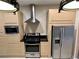 Modern kitchen featuring stainless steel appliances, sleek cabinets, and a contemporary design at 7667 Recife Dr, Kissimmee, FL 34747