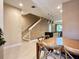 Open-concept living area featuring stairs, pendant lighting and a kitchen with an island at 7667 Recife Dr, Kissimmee, FL 34747