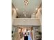 Beautiful living area featuring soaring ceilings and contemporary chandelier at 7667 Recife Dr, Kissimmee, FL 34747