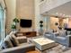 Open living area with contemporary furnishings, a large TV, and an open view of the kitchen at 7667 Recife Dr, Kissimmee, FL 34747