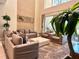 Spacious living room featuring plush seating, a modern coffee table, and stylish decor at 7667 Recife Dr, Kissimmee, FL 34747