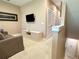 Cozy living room features neutral tones, mounted television, and comfortable seating at 7667 Recife Dr, Kissimmee, FL 34747