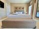 Spacious main bedroom features a king bed, art, and an ottoman at 7667 Recife Dr, Kissimmee, FL 34747