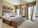 Serene main bedroom showcasing a king bed, decorative art, and bright natural light at 7667 Recife Dr, Kissimmee, FL 34747