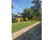 Spacious backyard showcasing a brick paver patio, lawn, a wooden fence, and mature trees at 802 Kaywood Dr, Orlando, FL 32825