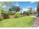 This sprawling backyard features lush green grass and a wooden privacy fence at 802 Kaywood Dr, Orlando, FL 32825