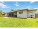 Spacious backyard featuring a lush lawn and a screened-in patio, perfect for outdoor living at 802 Kaywood Dr, Orlando, FL 32825